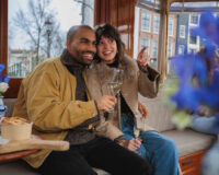 Young couple pointing at their nice view from their canal cruise tour